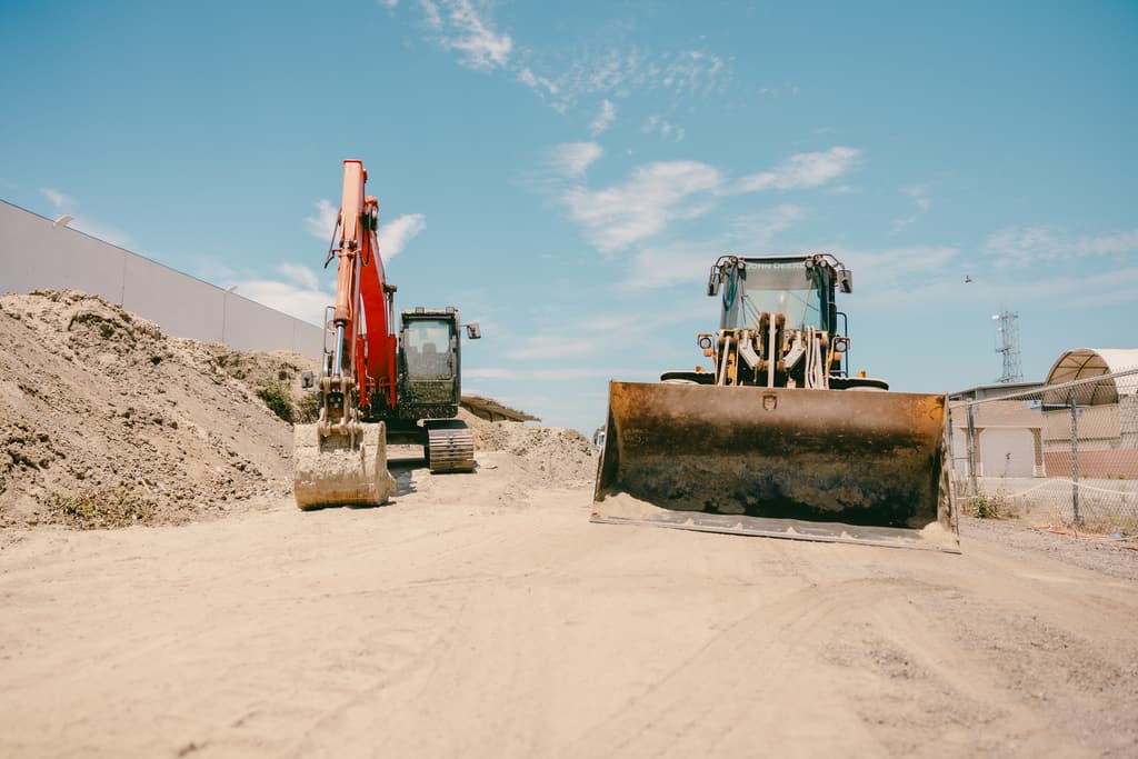 Excavator and wheel loader parked on the yard road